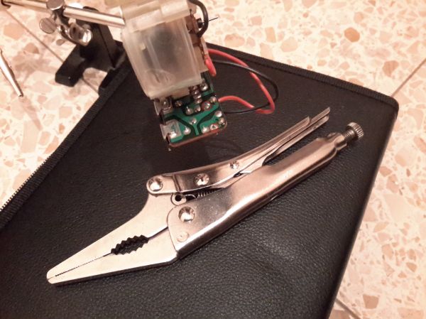 Step 11: solder points of resistor R2 (15k Ohm)
desolder resistor R2, locking pliers are one way to pull the resistor leg loose once the solder point is softened

