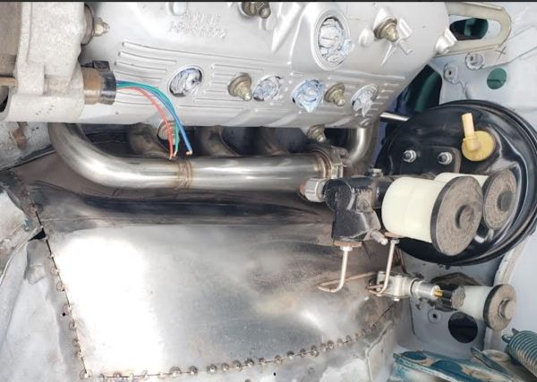 Driver_side_exhaust_header_and_brake_master_booster2.jpg